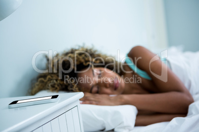 Young woman sleeping on bed