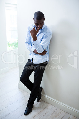 Tensed man leaning on wall