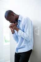 Tensed man leaning on wall