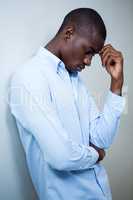 Tensed man leaning on wall