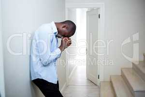 Tensed man leaning on wall