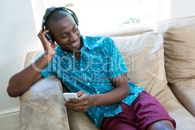 Thoughtful man listening to music on headphone