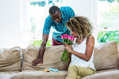 Woman smelling bunch of rosses gifted by man