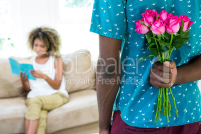 Man hiding flower from the woman