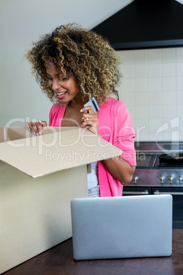 Happy woman looking into the parcel