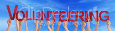 Many People Hands Holding Red Straight Word Volunteering Blue Sk