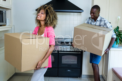 Young couple carrying carb board boxes