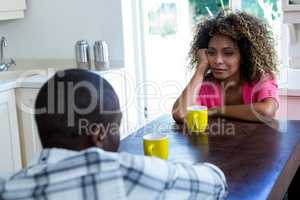 Young couple sitting on table with coffee mug