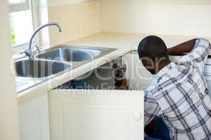 Man repairing a kitchen sink
