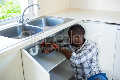 Man repairing a kitchen sink