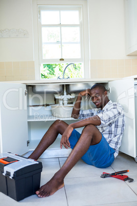 Portrait of man repairing a kitchen sink