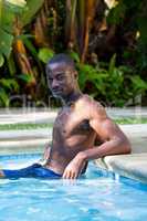 Confident man relaxing in swimming pool