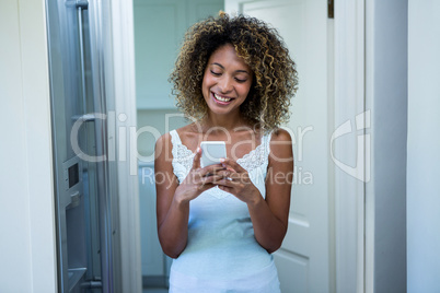 Young woman text messaging on phone