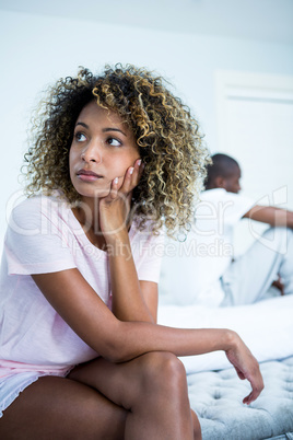 Upset couple ignoring each other after fight on bed