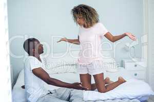 Young couple arguing on bed
