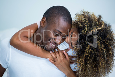 Young couple embracing each other in bedroom