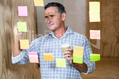 Man writing on sticky notes