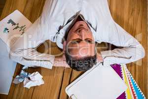 Thoughtful man lying on desk