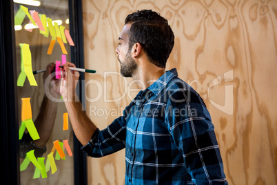 Man writing on sticky notes