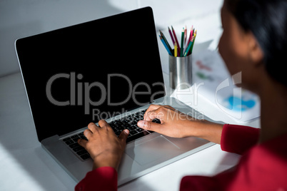 Woman using laptop in office