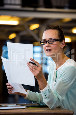 Woman reading a document in office