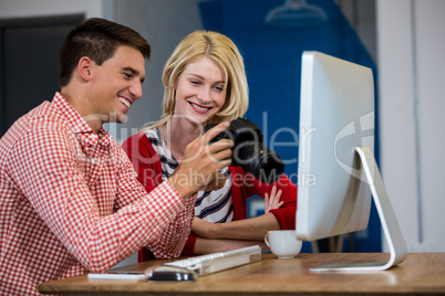 Colleagues looking at photos in camera