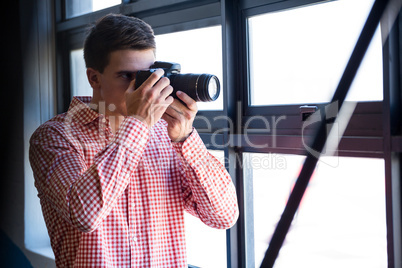 Man clicking photo from camera