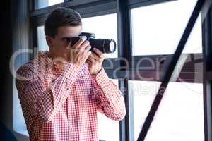 Man clicking photo from camera