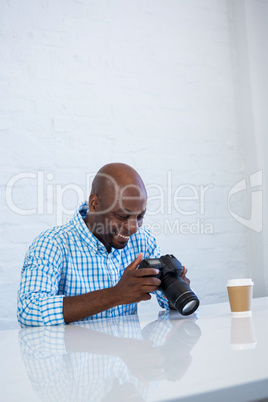 Man checking photo in camera