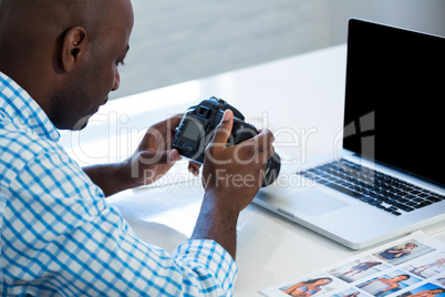 Man checking photo in camera