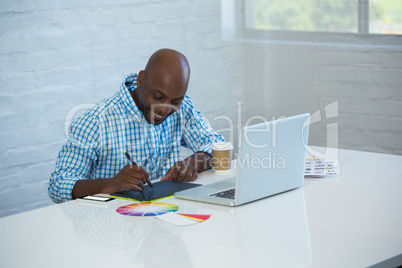 Graphic designer working on his graphics tablet