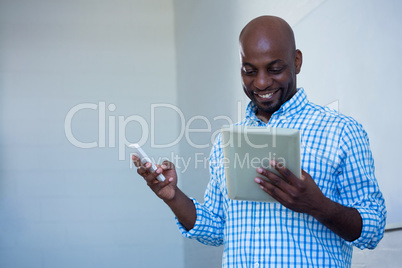 Man using digital tablet and mobile phone