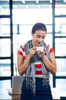 Beautiful woman smelling a cup of coffee