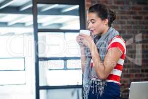 Beautiful woman smelling a cup of coffee