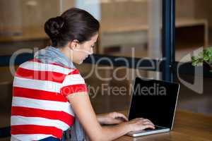 Woman using laptop in office