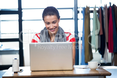 Happy woman using laptop