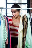 Woman selecting an apparel while shopping for clothes