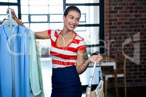 Woman selecting an apparel while shopping for clothes