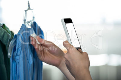 Woman clicking photo tag of garment