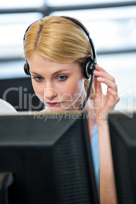 Woman working on computer with headset