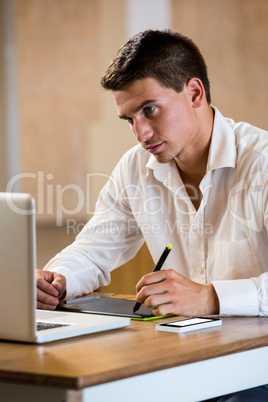 Man working on his graphics tablet Man working on his graphics tablet