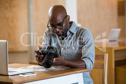 Man checking photo in camera