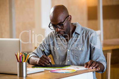 Man working on his graphics tablet Man working on his graphics tablet