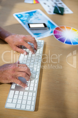Graphic designer typing on keyboard
