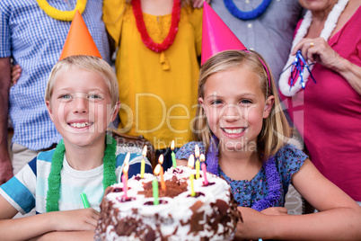 Siblings celebrating birthday party with family