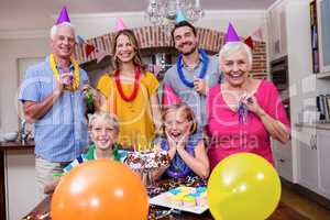 Multi-generation family having fun at birthday party