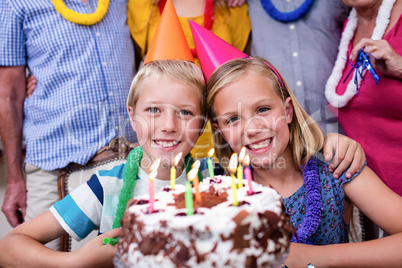 Siblings celebrating birthday party with family