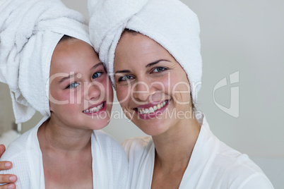 Portrait of mother and daughter in bathrobe