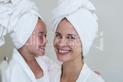 Girl in bathrobe looking her mother