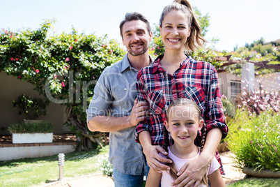 Happy family standing in the garden